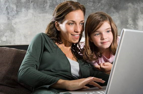 Mother and daughter at the computer.